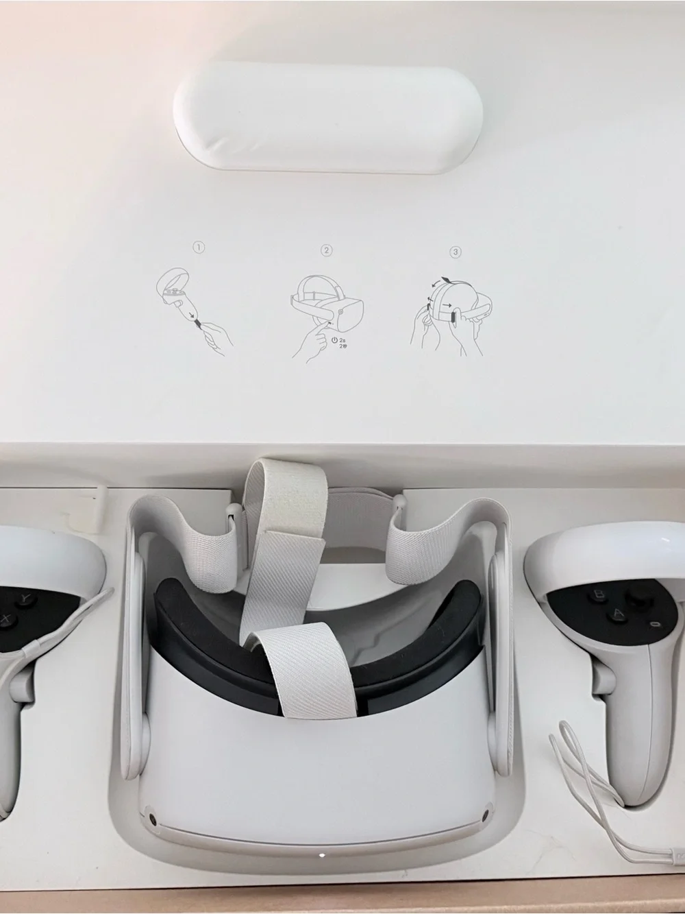 Oculus standalone VR headset with white controllers